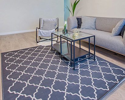 A blue and white color carpet and sofa